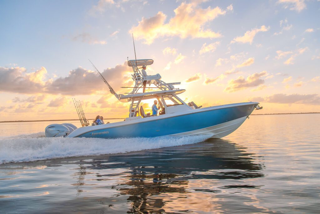 Blue boat in front of a sun set