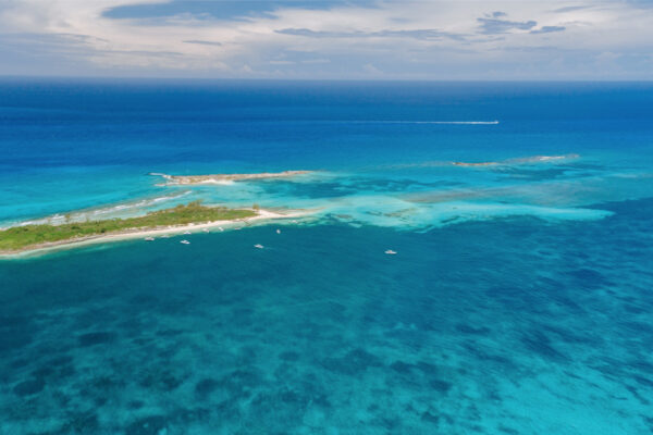 Birds eye perspective of fishing boats near a small island