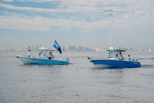 Two Everglades boats cruising side by side off the coast of Florida.