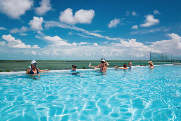 Group of people in a pool and enjoying drinks