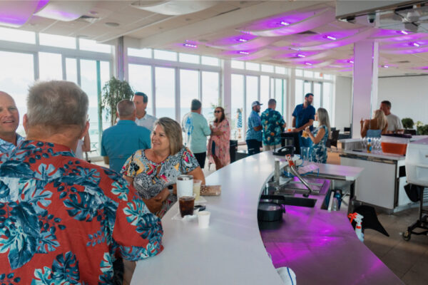 Indoor party with people conversing and having drinks