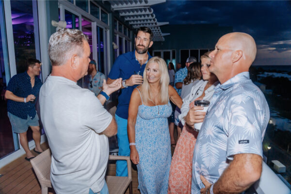 Night party on a deck with people enjoying drinks